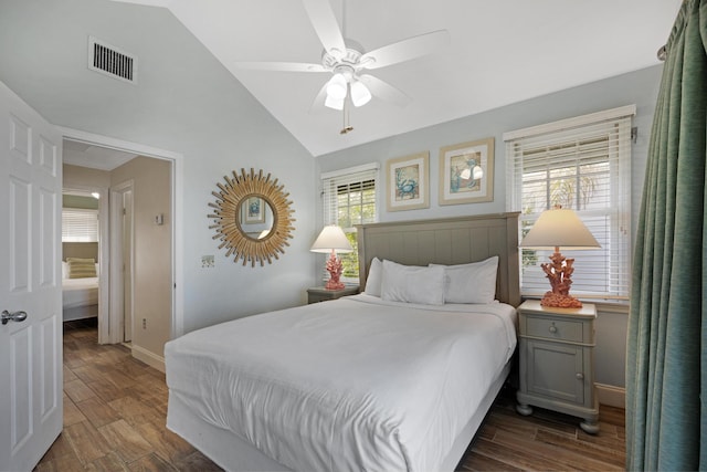 bedroom with dark wood-style floors, baseboards, vaulted ceiling, and visible vents