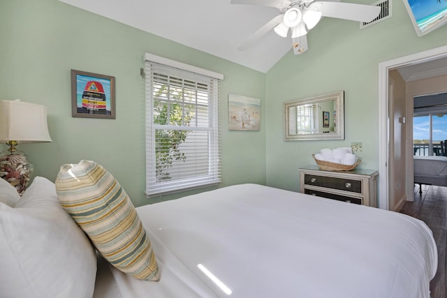 bedroom featuring a ceiling fan, visible vents, vaulted ceiling, and dark wood finished floors