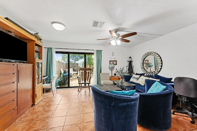 tiled living room featuring ceiling fan and a textured ceiling