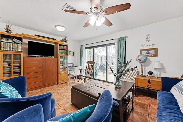 tiled living room with a textured ceiling and ceiling fan