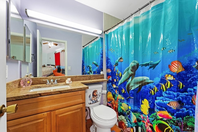 bathroom featuring vanity, ceiling fan, and toilet