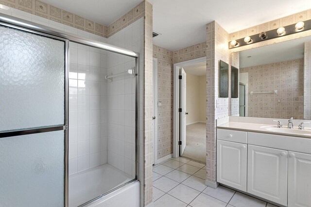 1660 S A1A Unit 222, Jupiter, FL 33477 - full bathroom with tile patterned floors, bath / shower combo with glass door, and vanity
