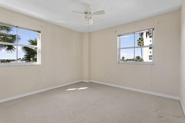 1660 S A1A Unit 222, Jupiter, FL 33477 - unfurnished room featuring carpet floors, plenty of natural light, a textured ceiling, and a ceiling fan