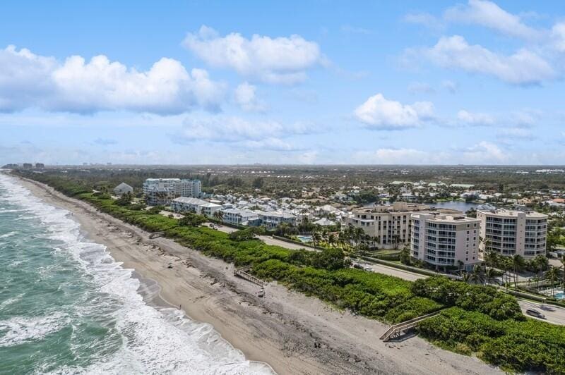 aerial view featuring a water view and a beach view