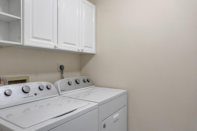 1660 S A1A Unit 222, Jupiter, FL 33477 - clothes washing area with independent washer and dryer and cabinet space