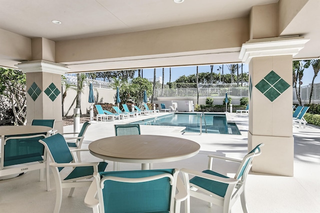 1660 S A1A Unit 222, Jupiter, FL 33477 - community pool with a patio, a fenced backyard, and outdoor dining area