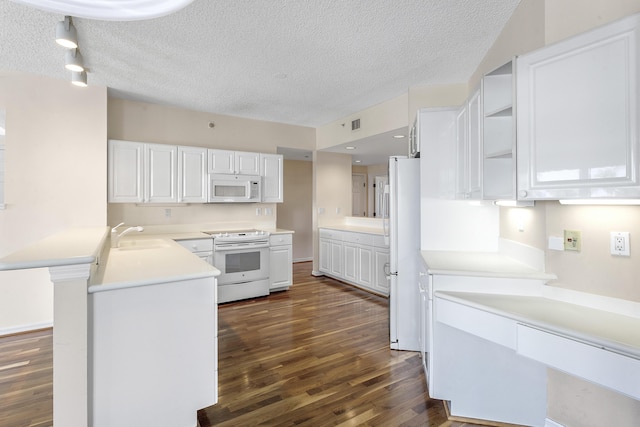 1660 S A1A Unit 222, Jupiter, FL 33477 - kitchen with white appliances, dark wood-style floors, a sink, a textured ceiling, and a peninsula