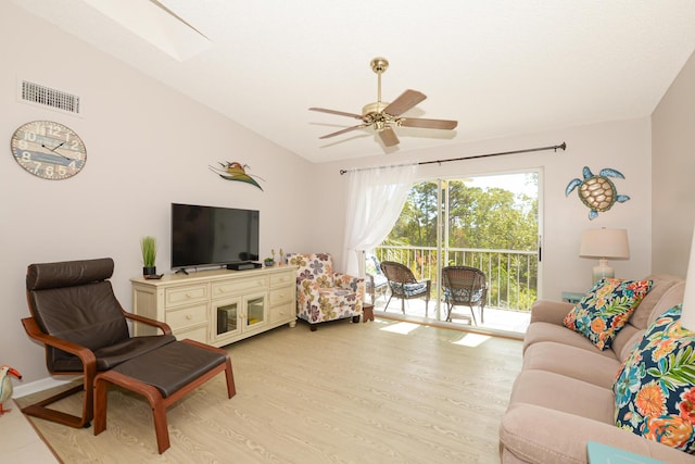 living room featuring lofted ceiling, ceiling fan, and light wood-type flooring