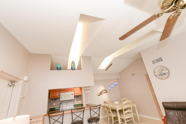 office area featuring lofted ceiling and a textured ceiling