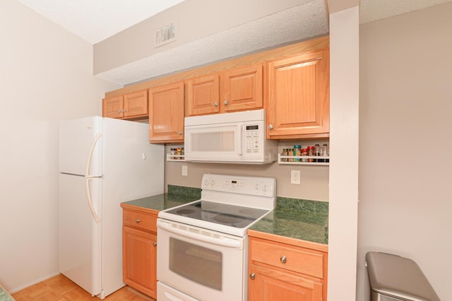 kitchen with white appliances, a textured ceiling, and light parquet floors