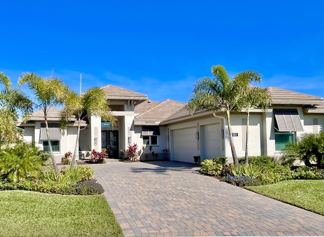 view of front of house with a garage and a front lawn