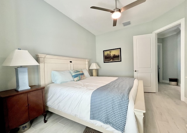 bedroom featuring ceiling fan, lofted ceiling, and light hardwood / wood-style floors