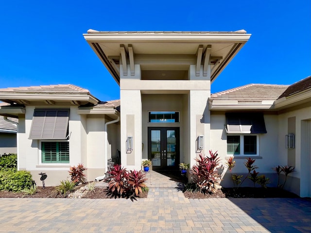 view of exterior entry featuring french doors