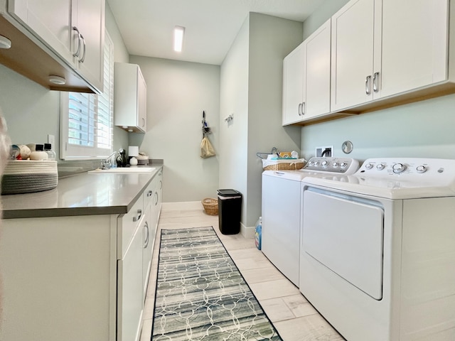 washroom with independent washer and dryer, sink, and cabinets