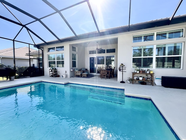 view of pool featuring ceiling fan, a lanai, and a patio area