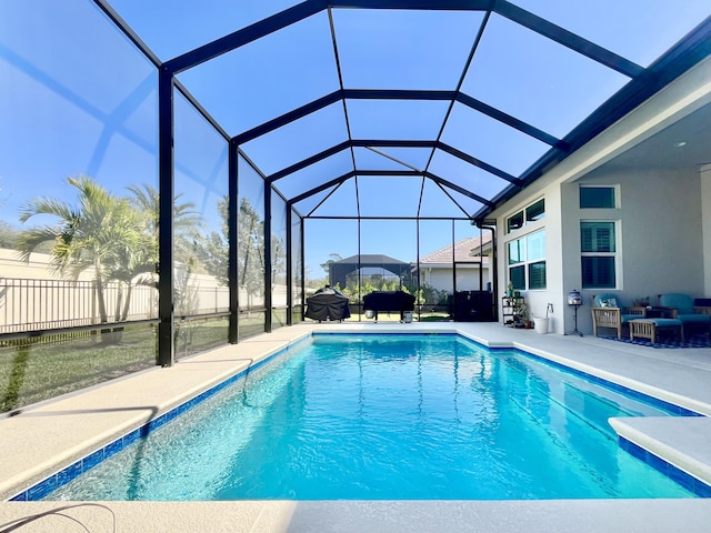 view of swimming pool featuring a lanai and a patio area