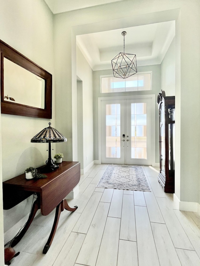 foyer entrance featuring a raised ceiling and french doors