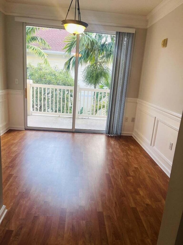 spare room featuring ornamental molding and dark hardwood / wood-style floors