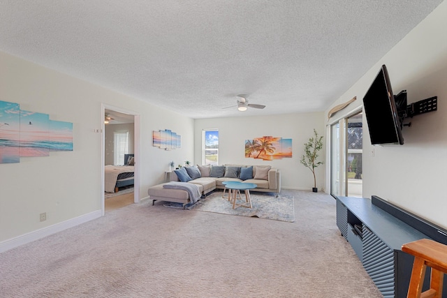 carpeted living room featuring a textured ceiling and ceiling fan