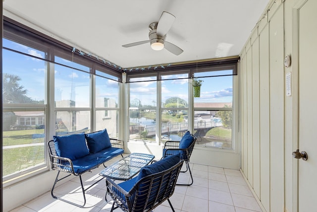 sunroom featuring a water view, a wealth of natural light, and ceiling fan