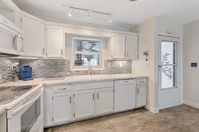 kitchen featuring sink, a textured ceiling, white appliances, decorative backsplash, and white cabinets