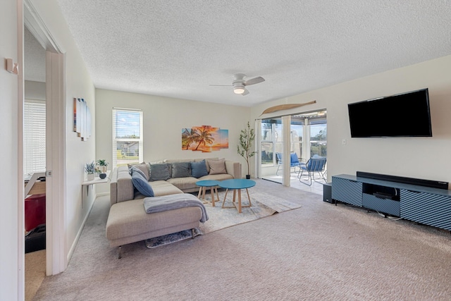 carpeted living room with a textured ceiling and ceiling fan