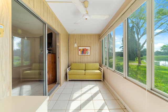 unfurnished sunroom with ceiling fan