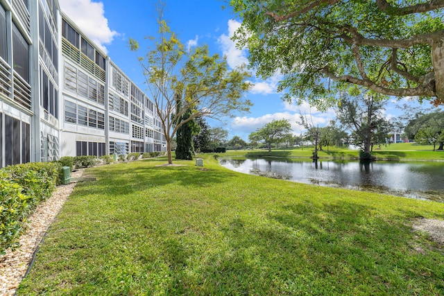 view of home's community featuring a water view and a lawn