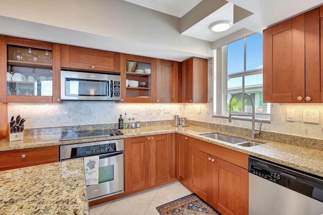 kitchen featuring sink, backsplash, light tile patterned floors, light stone counters, and stainless steel appliances