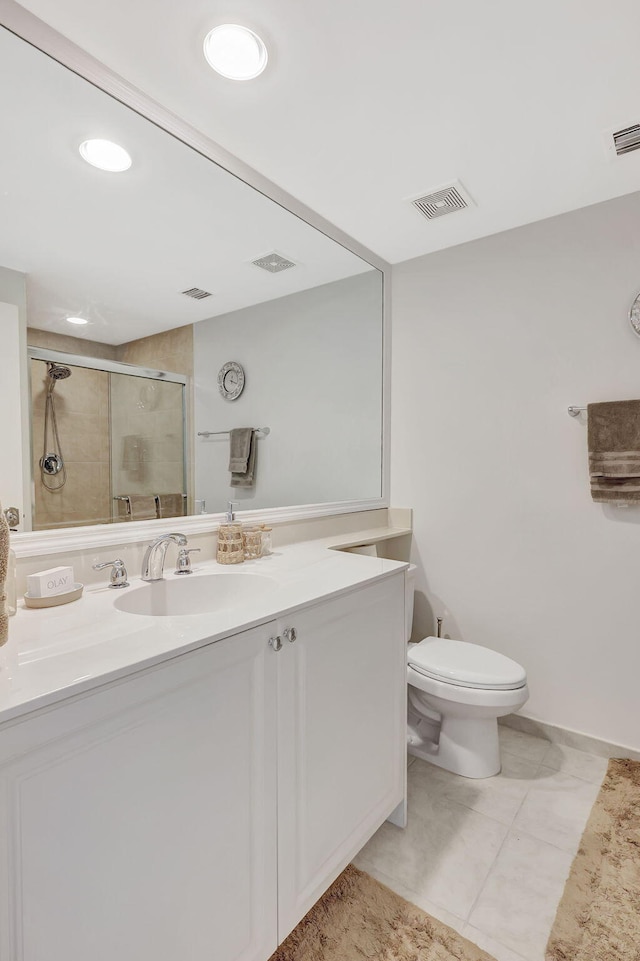 bathroom with vanity, toilet, and a shower with shower door