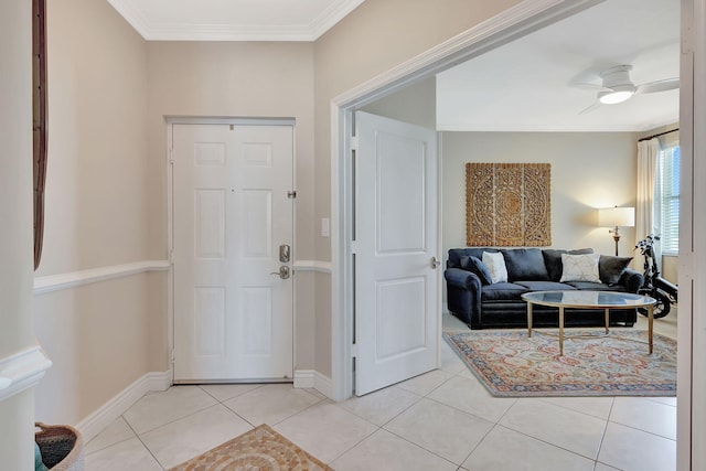 foyer featuring light tile patterned floors, crown molding, and ceiling fan