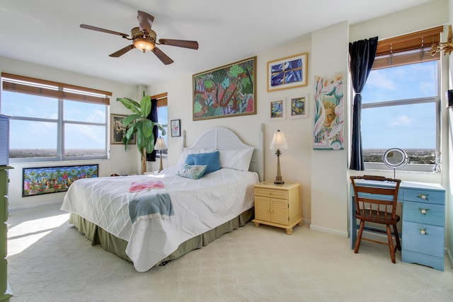 bedroom featuring light colored carpet and ceiling fan