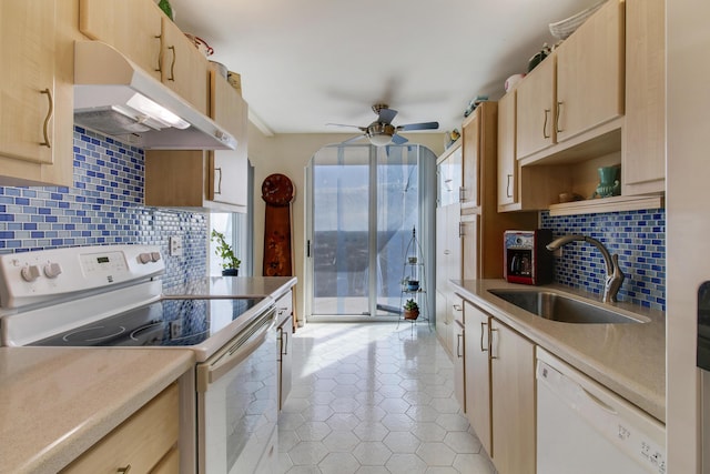 kitchen with light brown cabinetry, sink, light tile patterned floors, ceiling fan, and white appliances