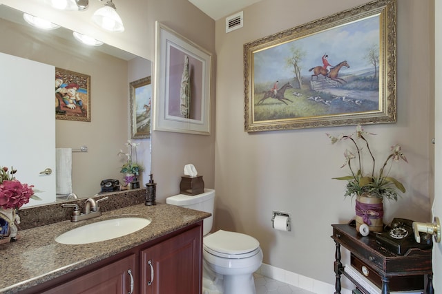 bathroom with tile patterned floors, vanity, and toilet