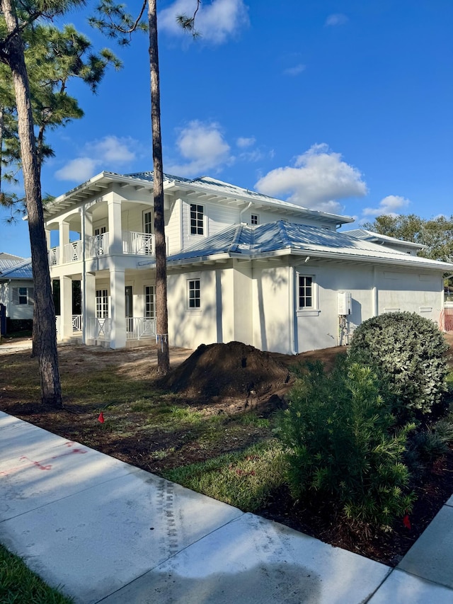 view of side of home featuring a balcony