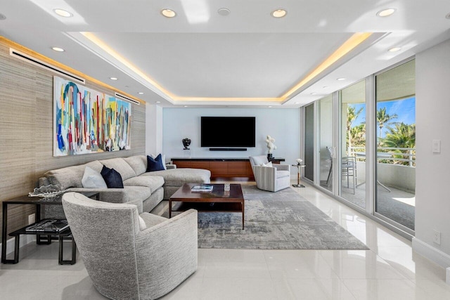 living room featuring a wall of windows and a tray ceiling