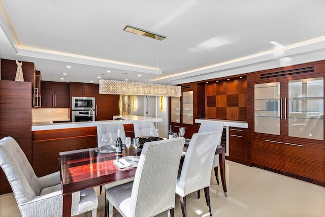 dining area with a raised ceiling