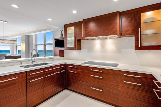 kitchen with black electric cooktop, sink, and light tile patterned floors