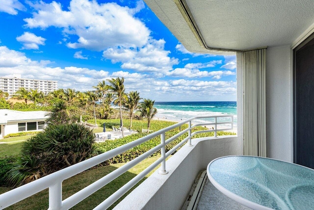 balcony featuring a beach view and a water view