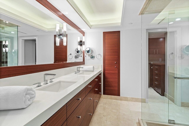 bathroom with vanity, an enclosed shower, and a raised ceiling