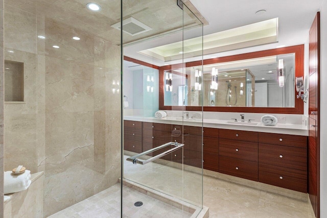 bathroom with vanity, a tray ceiling, and a shower with shower door