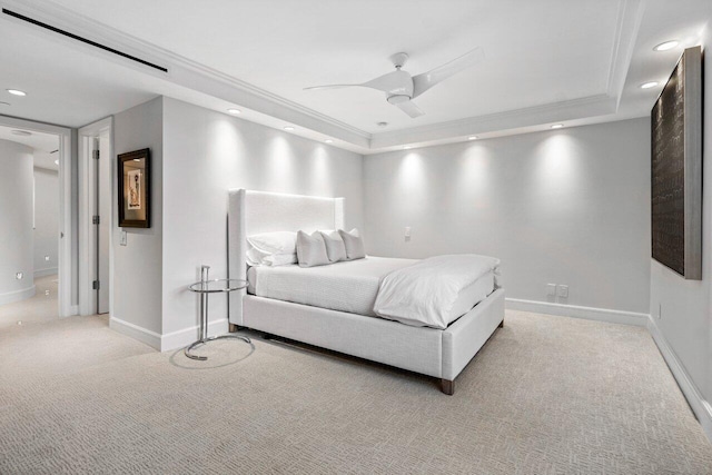 bedroom featuring crown molding, light colored carpet, a raised ceiling, and ceiling fan