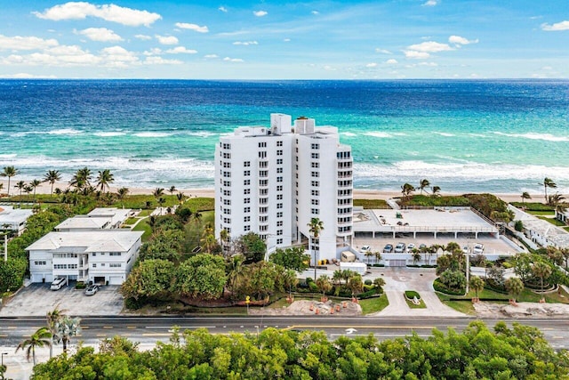 aerial view with a water view and a beach view