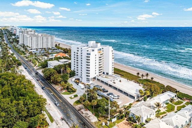 birds eye view of property with a water view and a view of the beach