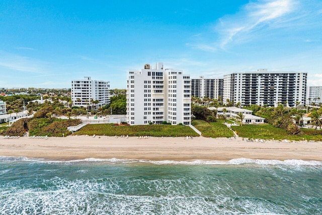 view of property with a view of the beach and a water view