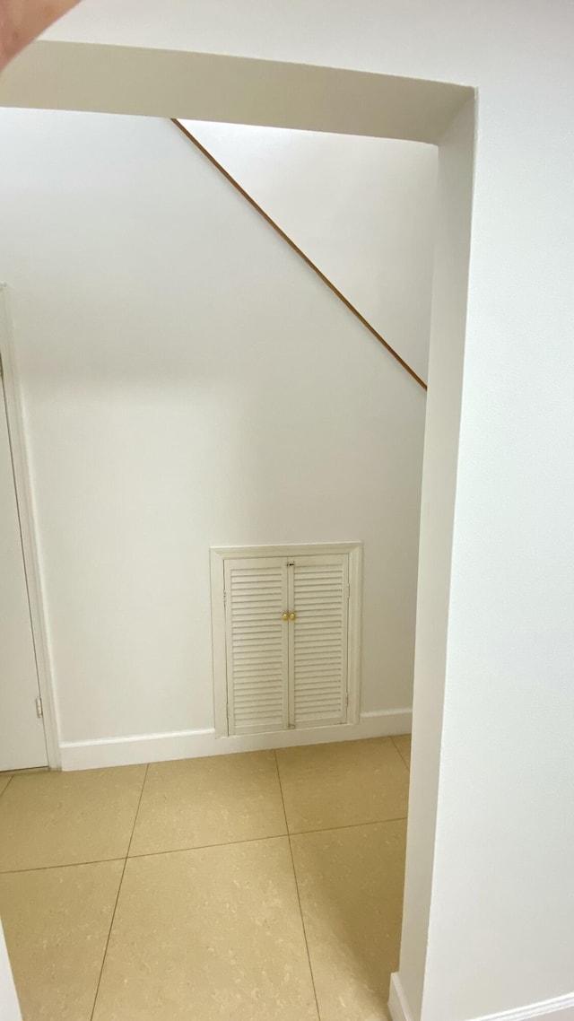 interior space with light tile patterned floors and baseboards