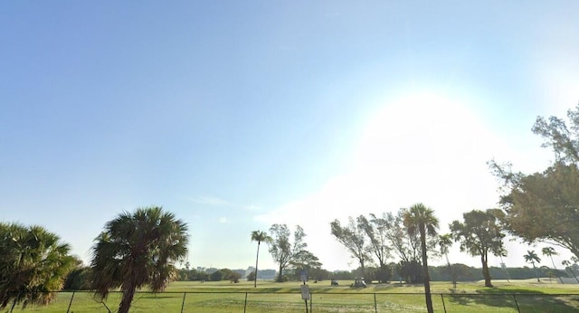 view of property's community with a rural view and a lawn