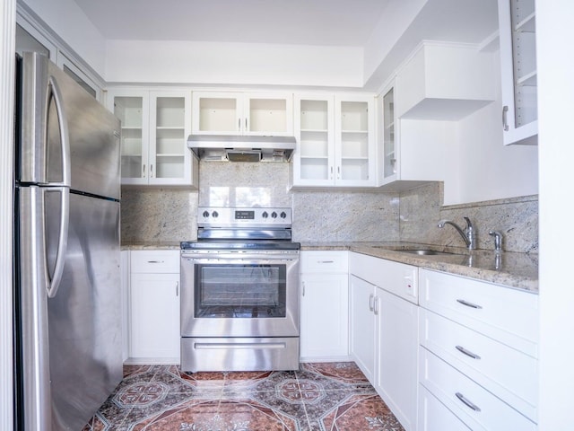 kitchen with sink, light stone counters, appliances with stainless steel finishes, decorative backsplash, and white cabinets