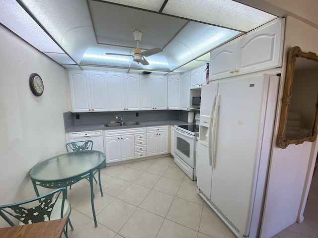 kitchen featuring white cabinetry, sink, white appliances, and light tile patterned flooring