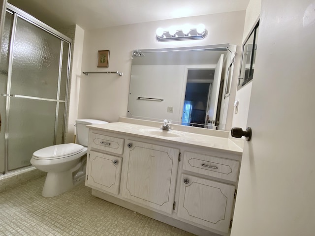 bathroom featuring vanity, an enclosed shower, and toilet